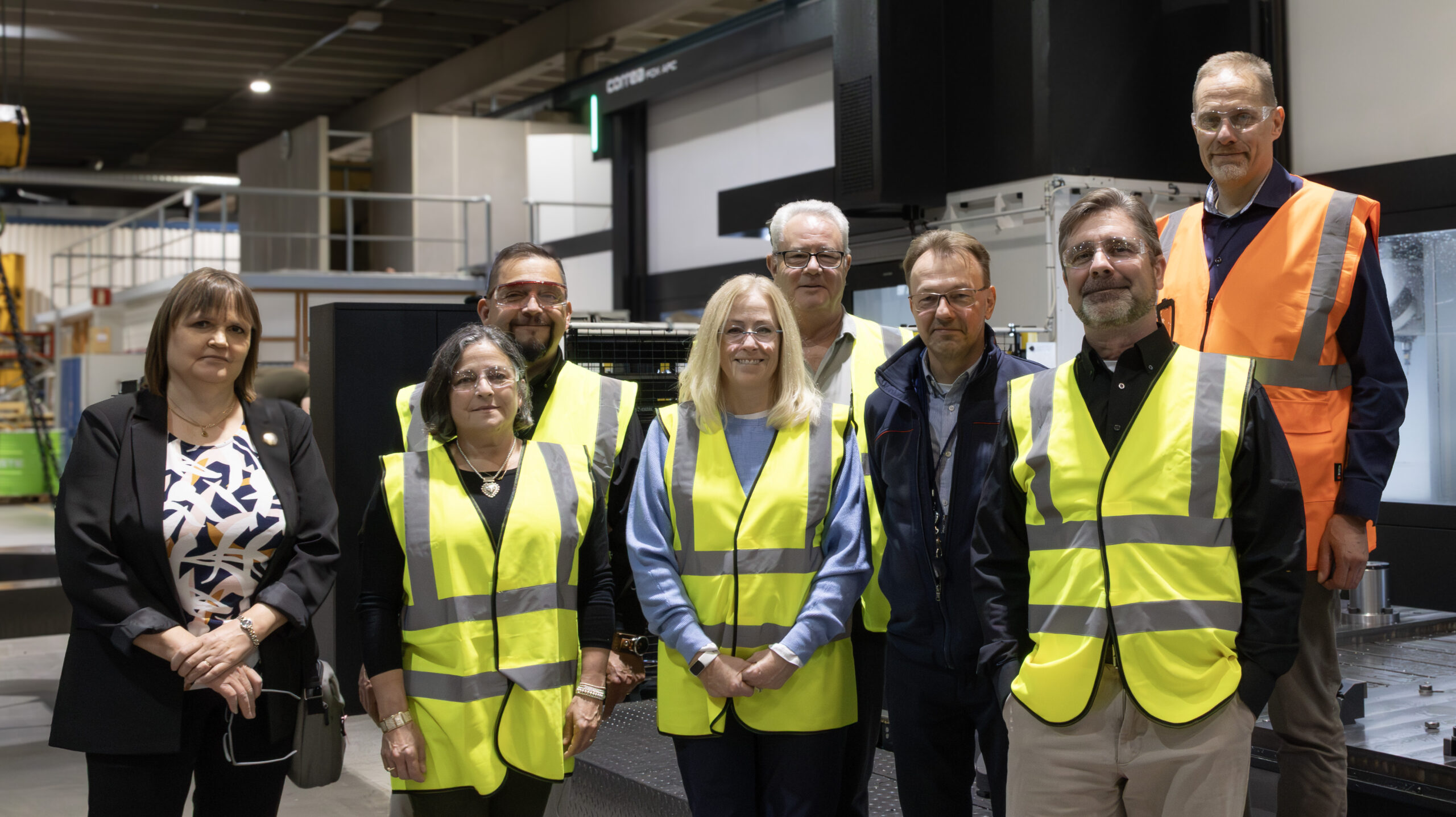 Key Industrial Hose and Finn-Power representatives stand and smile at the camera