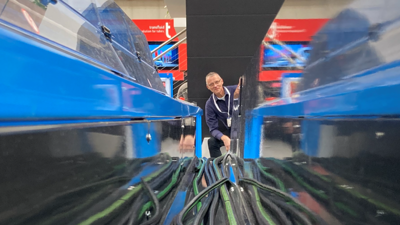 Man looks at camera through a Finn-Power machine